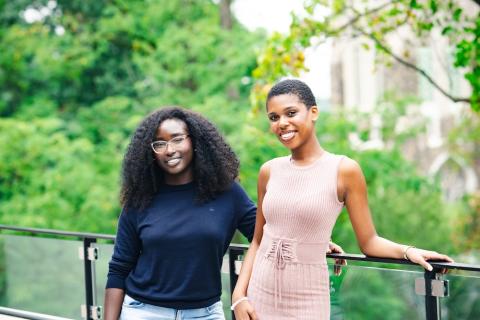 Lya Joseph ‘25 ‘26G and Emmanuella Agyemang ‘26 pose for a portrait smiling at the camera.